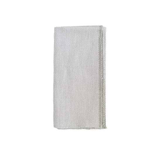 Folded greige and white zigzag napkin