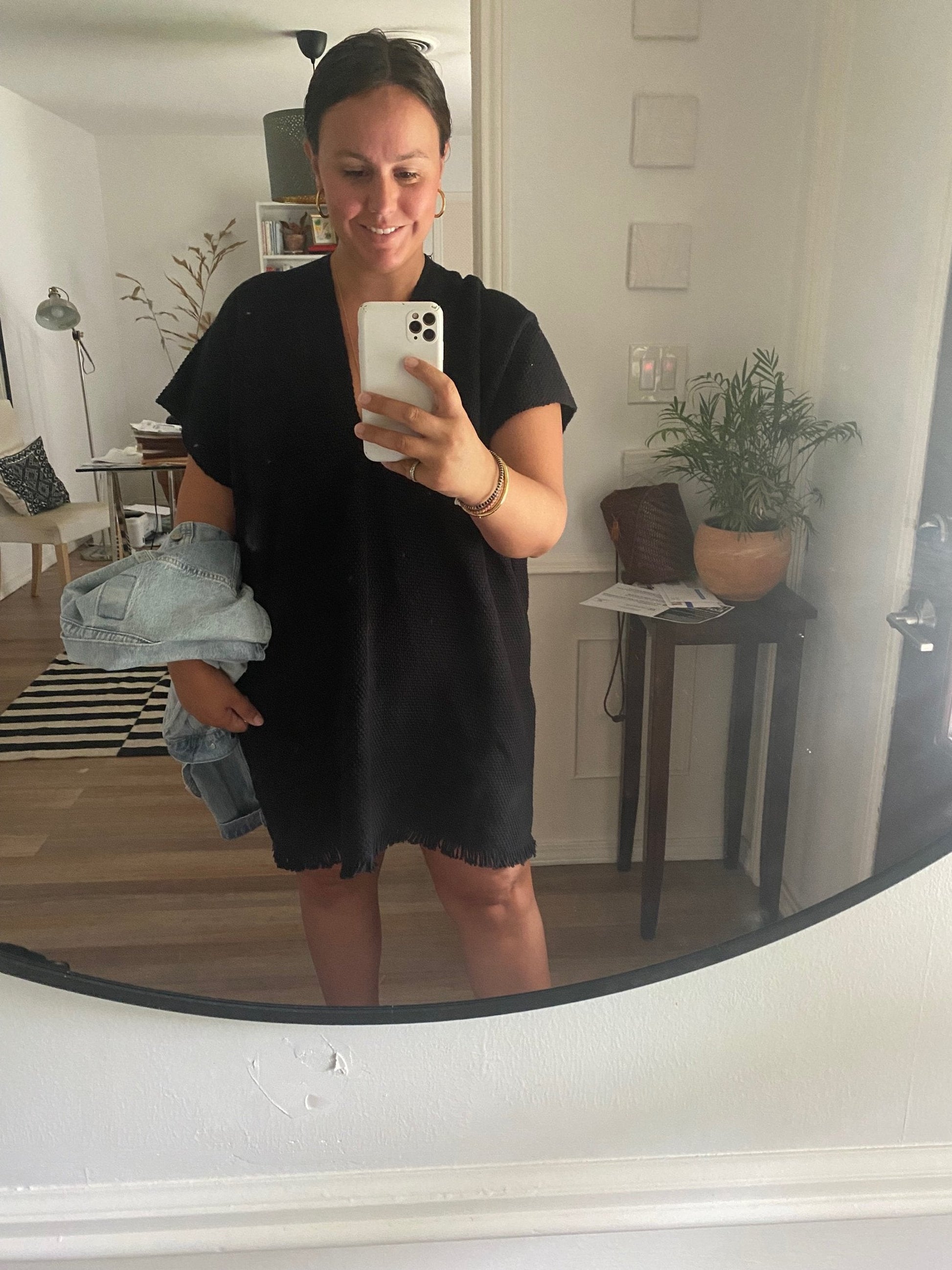 Mirror selfie of woman wearing black caftan