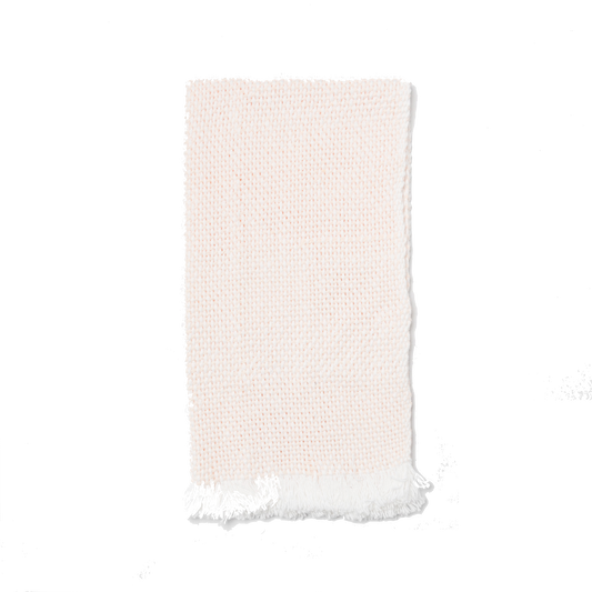 Folded white and blush hand towel