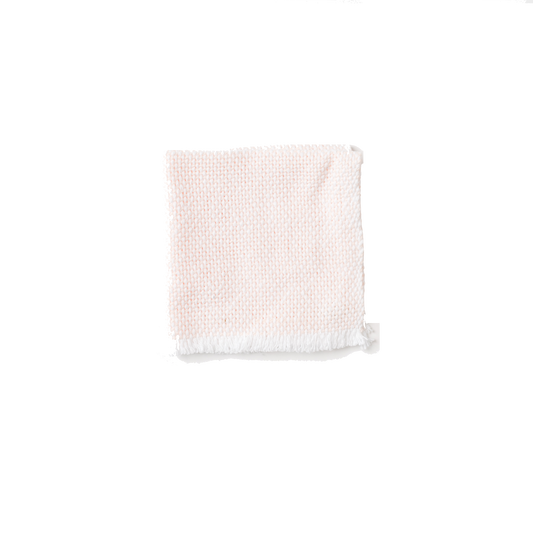 Folded white and blush wash cloth